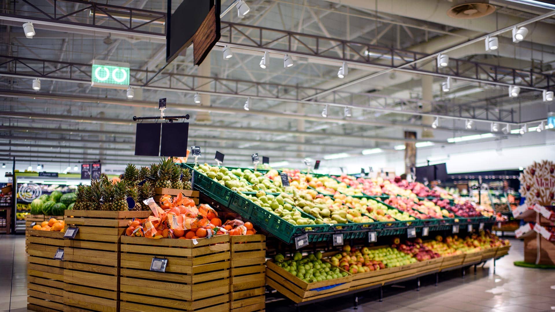 Juno track lighting system illuminates produce in a grocery store.