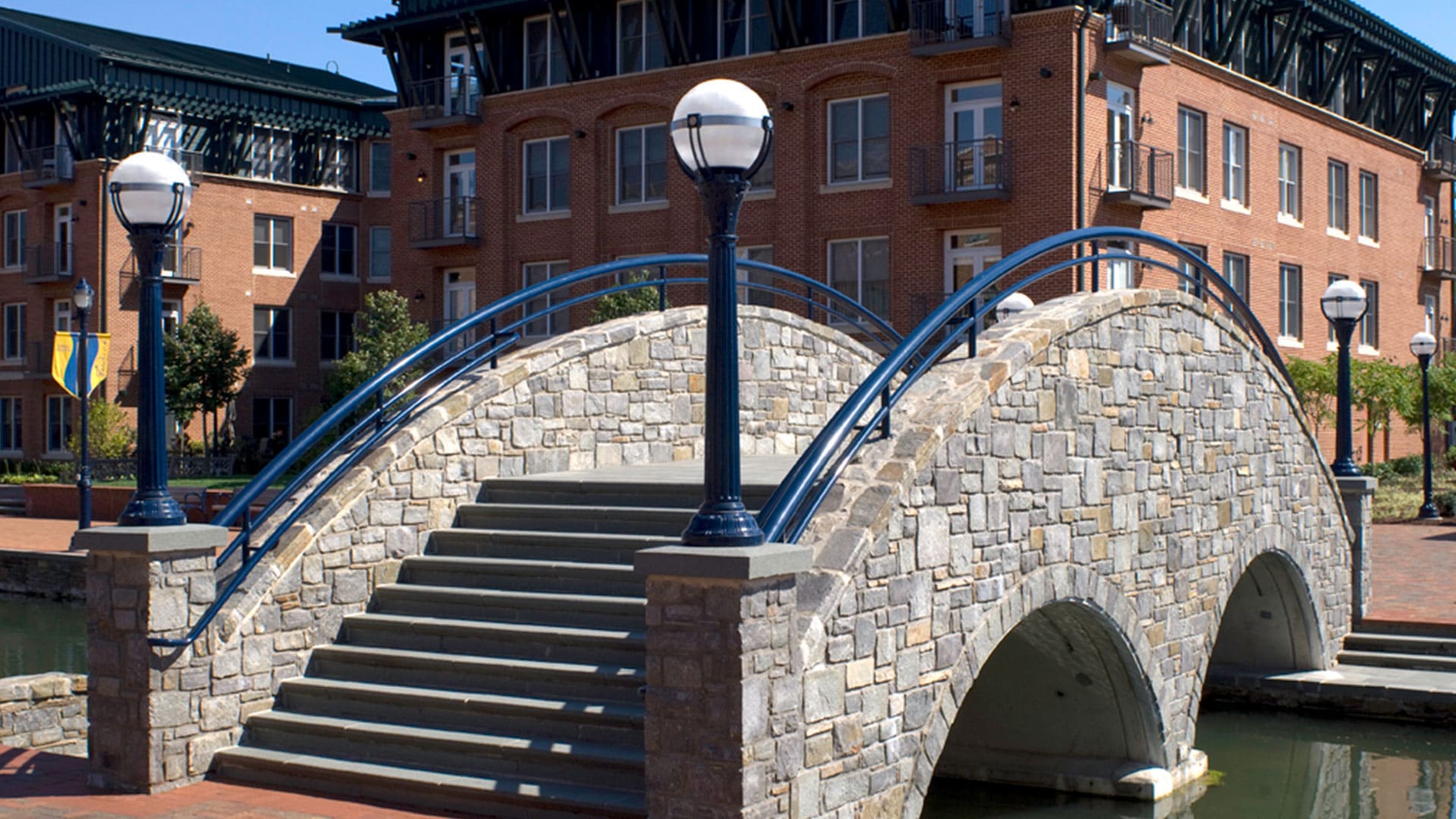 Holophane's sphere lights decorate the bridge over a campus creek.