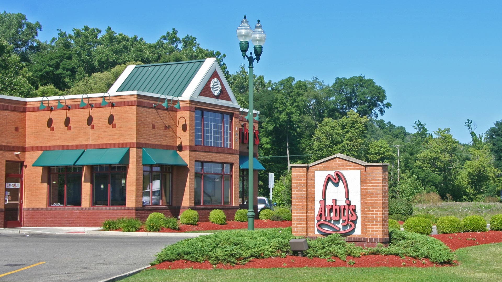 Washington acorn lights being used to illuminate restaurant parking lot.