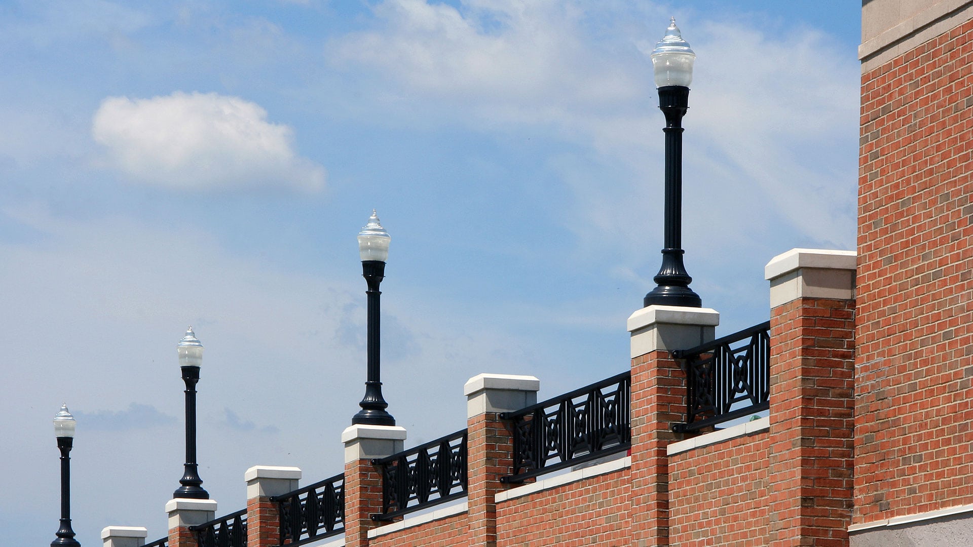 Holophane's LED post-top lights used to line top-level parking deck.