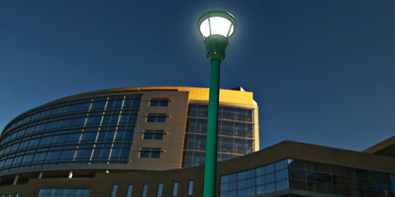 A post-top LED lantern light from Holophane lights the outdoor area of an office building.