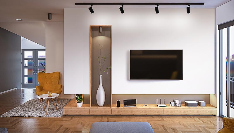 Juno Trac-Lites track lighting system illuminates living room wall.
