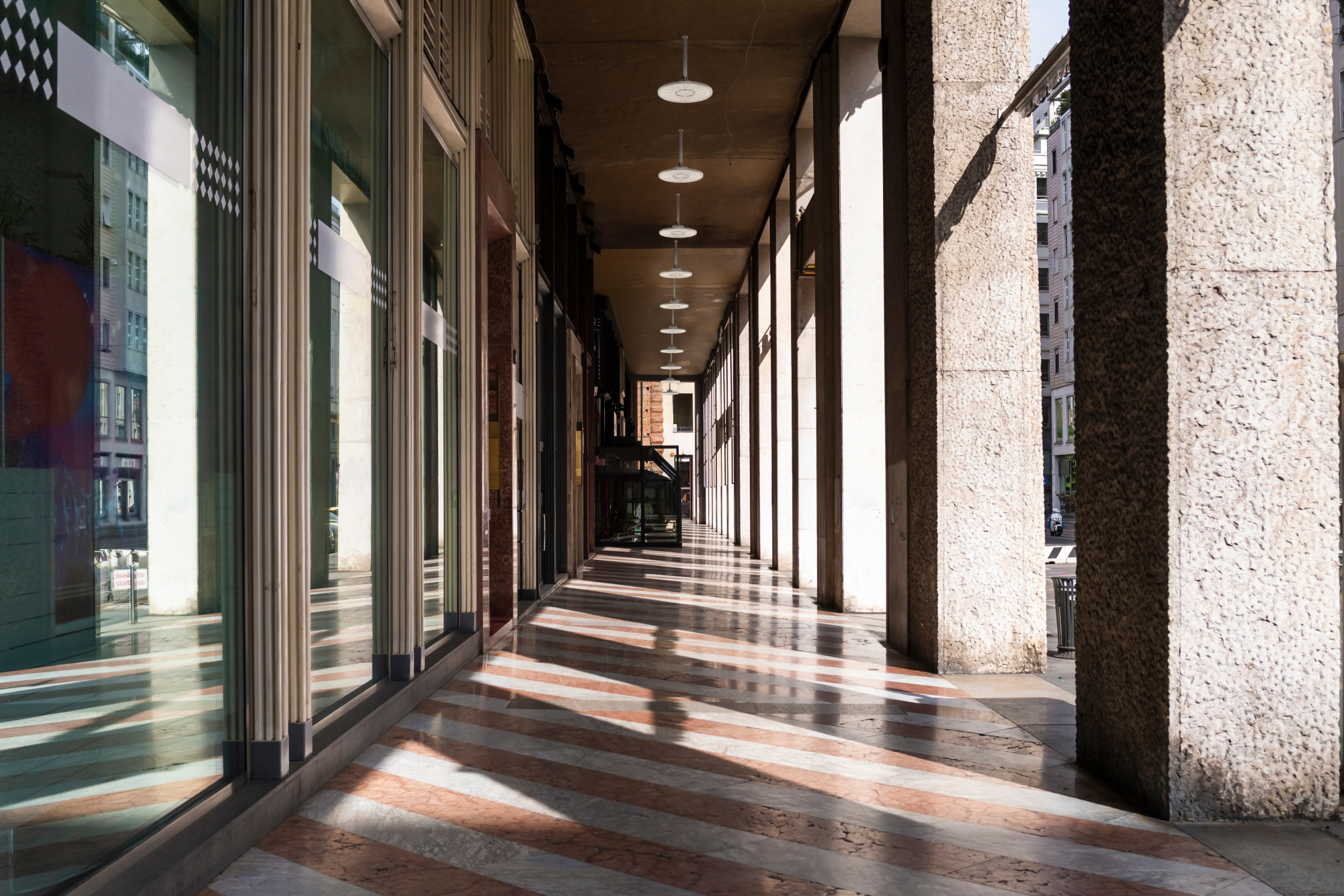 Compact Pro™ LED Round High Bay fixtures from Lithonia Lighting illuminate the outdoor canopy of commercial building.