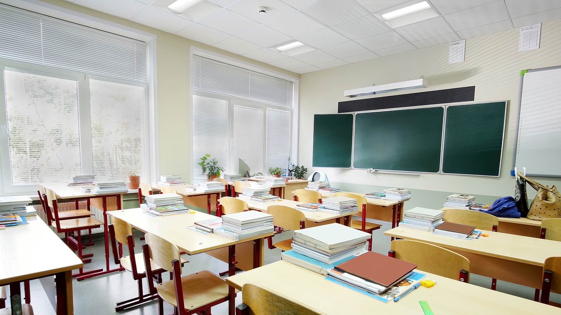 A prepared classroom illuminated by Lithonia's 2x2 center-element LED lay-in lights.