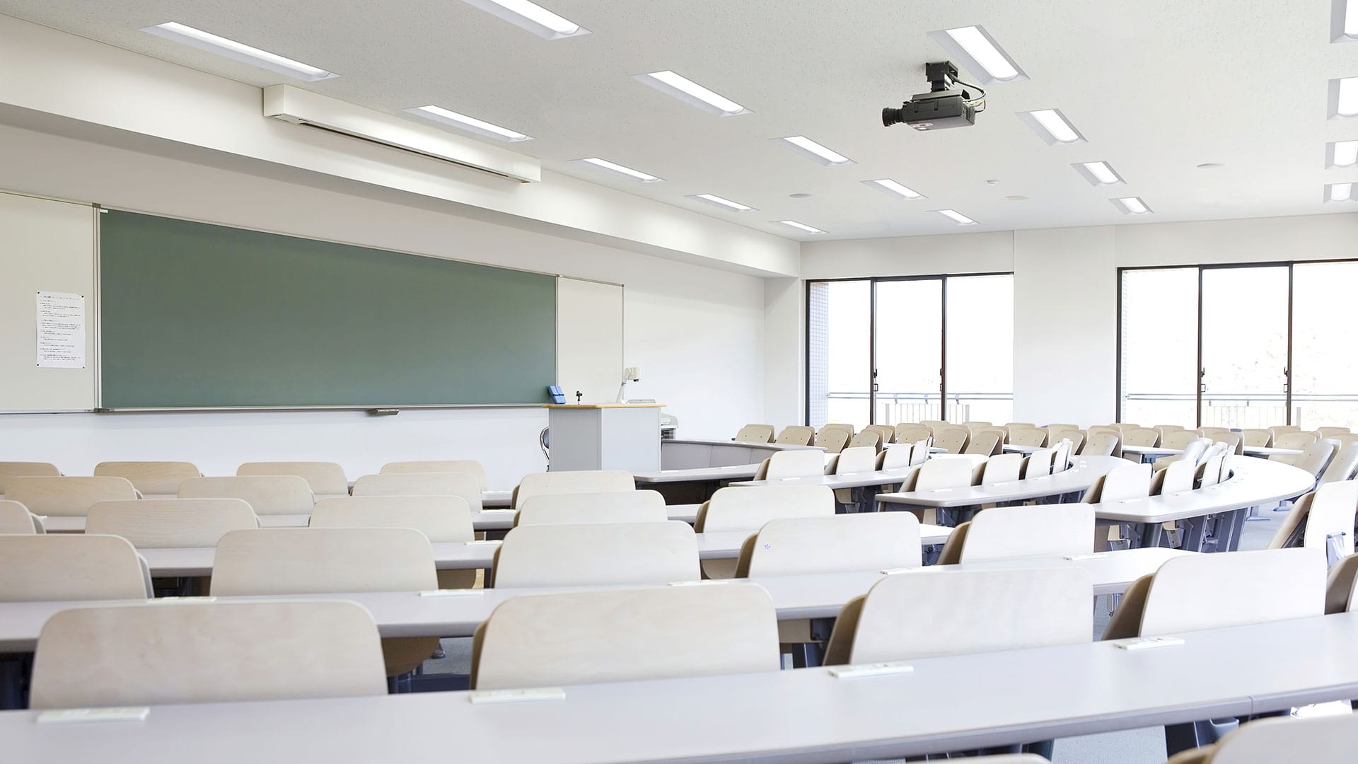 Lithonia's STACK LED lay-in lights illuminate the lecture hall on a college campus.