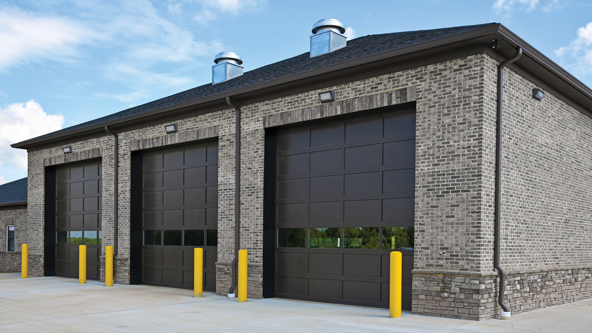 Commercial building with TWR led wall packs above large garage doors