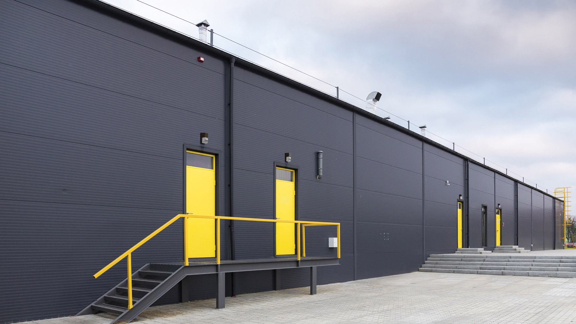 Large warehouse with TWR led wall packs above personnel doors