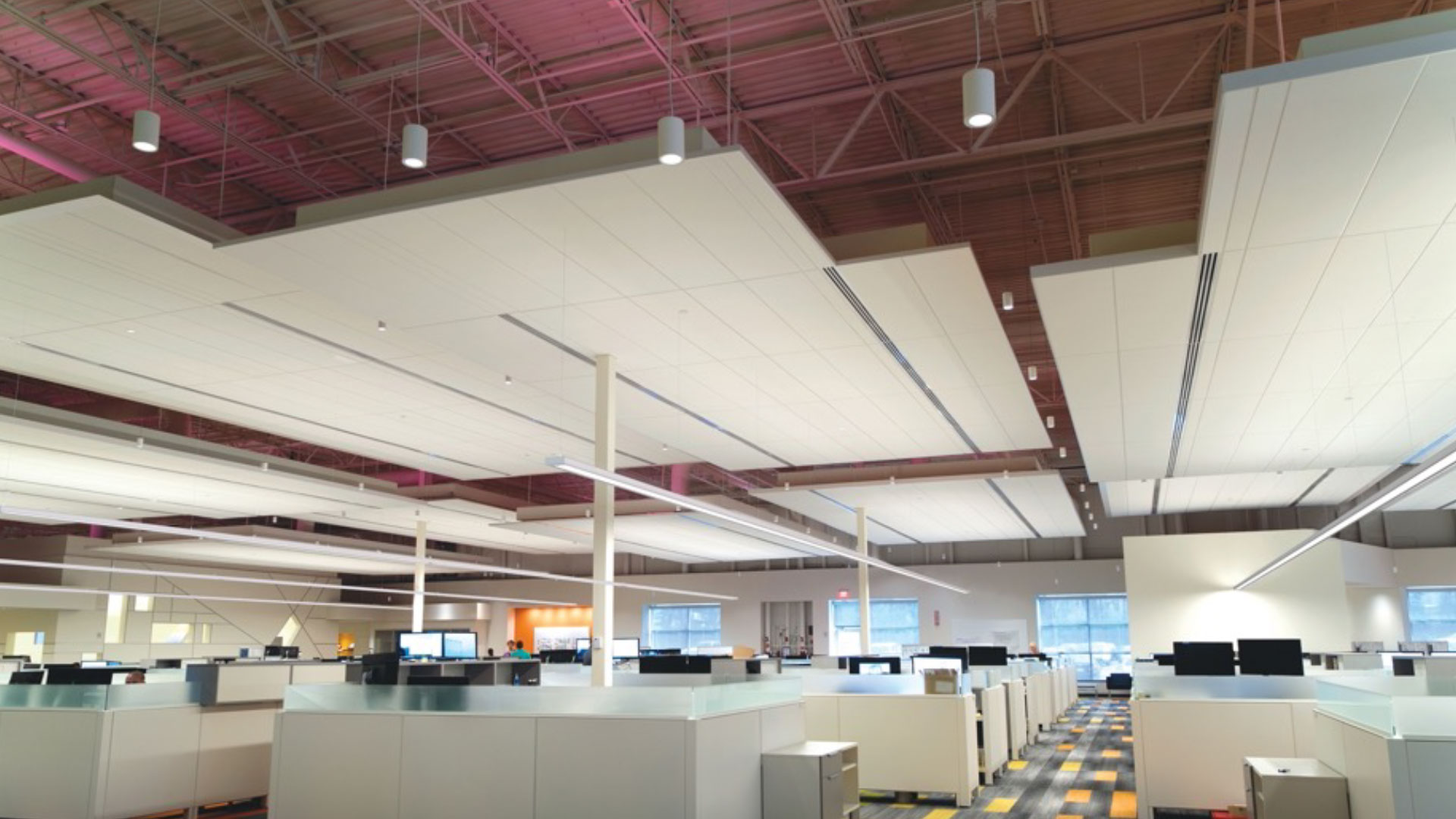 An open office space illuminated by Peerless Proper suspended linear fixtures.